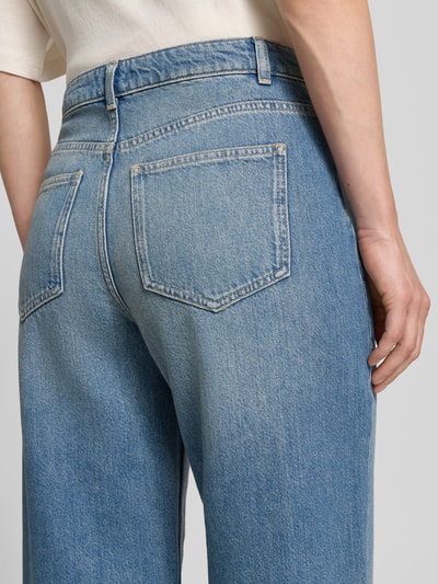 Frauenmodel trägt Wide Fit Jeans mit Lyocell-Anteil von Jake*s Casual in Jeansblau, feste Textur, aufgesetzte Taschen, Nahaufnahme Rückansicht. Baumwoll-Mix, Bundweite 38 cm, Innenbeinlänge 75 cm.