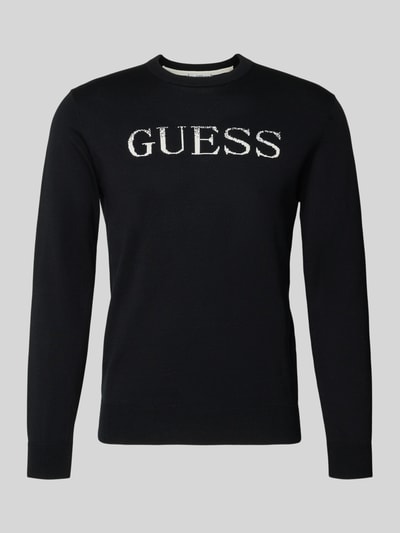 Produktfoto, schwarzer Regular Fit Pullover in Strick-Optik Modell 'Kane' von Guess aus reiner Baumwolle mit weißem Logo-Stitching auf der Brust.