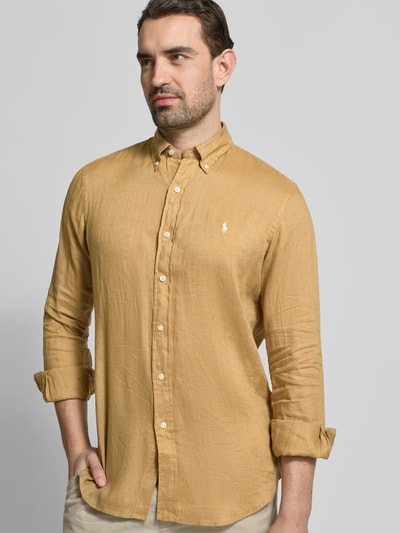 Männermodel trägt Regular Fit Freizeithemd aus reinem Leinen von Polo Ralph Lauren in uni senfgelb mit Button-Down-Kragen, Nahaufnahme Oberkörper