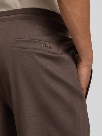 Männermodel trägt Sweatpants mit Eingrifftaschen Modell 'Josemiguel' von JOOP! Collection in Braun, reine Baumwolle, Nahaufnahme Rückansicht.