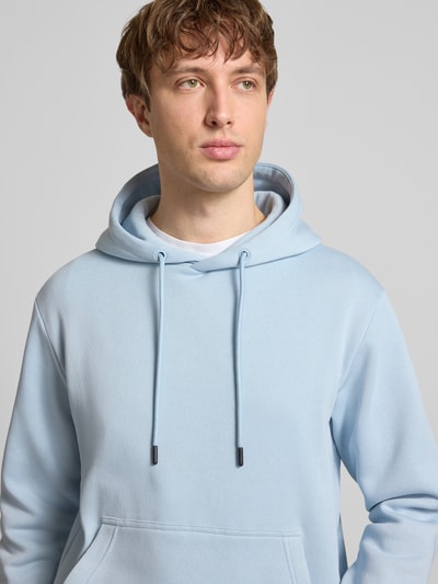 Männermodel trägt Hoodie mit Kapuze Modell 'BRADLEY' von Jack & Jones, hellblau, Baumwoll-Mix, Känguru-Tasche, Nahaufnahme Oberkörper.