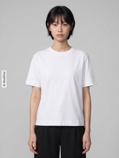 Frauenmodel trägt weißes Boxy Fit T-Shirt aus Baumwoll-Viskose-Mix Modell 'ESSENTIAL' von Selected Femme, Damen T-Shirt, Ganzkörperansicht von vorne, KI-modifiziertes Bild.