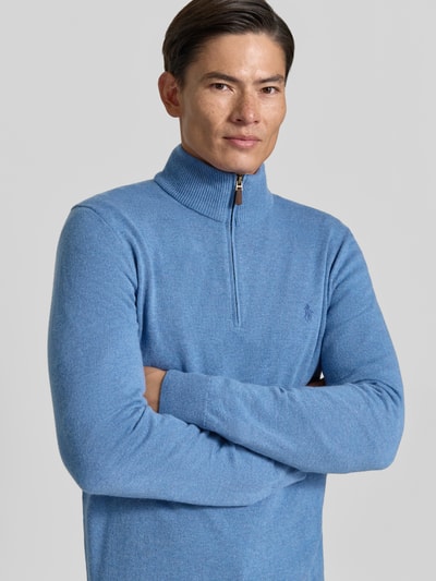 Mężczyzna nosi Regular Fit Troyer aus reiner Wolle von Polo Ralph Lauren, jasnoniebieski sweter wełniany, zamek pod szyją, gładka faktura, z przodu haft logo, Nahaufnahme Oberkörper.