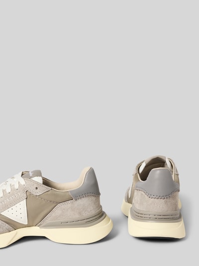 Produktfoto, Sneaker aus beschichtetem Leder mit Label-Detail von Clarks, Modell CraftWick, beige und grau, abgerundete Form, profilierte Sohle, Schnürung, sichtbar sind Absatz- und Schafthöhe sowie Schaftweite bei Größe 44