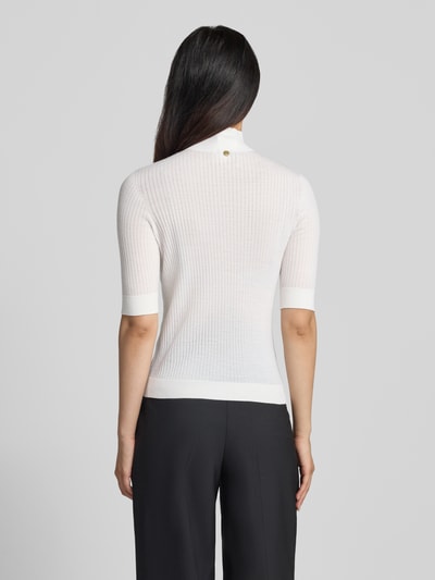 Frauenmodel trägt Slim Fit Longsleeve aus reiner Lanawolle Modell 'Maglia Costine' von Liu Jo White, semitransparent, weiß, Stehkragen, 1/2-Arm, Rückenansicht, Ganzkörperansicht Rückansicht.