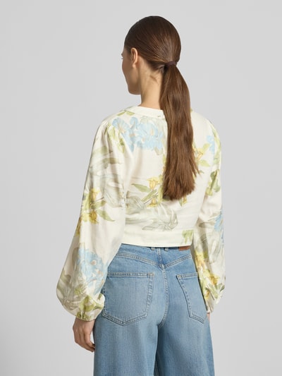 Frauenmodel trägt Cropped Bluse aus Leinen-Viskose-Mix Modell 'SHIRLEY' von Guess mit Blumenmuster in Pastell, Ganzkörperansicht Rückansicht. Damen Bluse mit V-Ausschnitt, Knopfleiste, Rückenlänge 42 cm, Ärmellänge 60 cm.