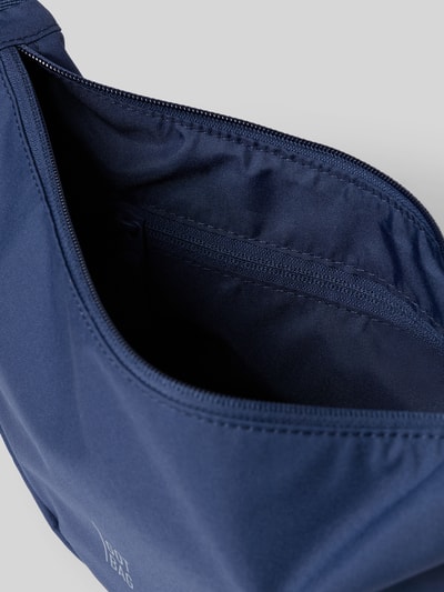 Produktfoto, Umhängetasche mit Label-Detail von Gotbag in Dunkelblau, Hauptfach mit Reißverschluss, Innenfach mit Reißverschluss, Größe 32x19x10 cm, verstellbarer Schulterriemen 82 cm.