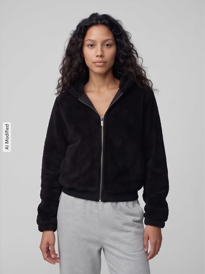 Frauenmodel trägt Regular Fit Sweatjacke mit Kapuze Modell 'NEWANNA' von ONLY, schwarze Farbe, flauschige Textur, Ganzkörperansicht von vorne, Damen Sweatjacke von ONLY, KI-modifiziertes Bild.
