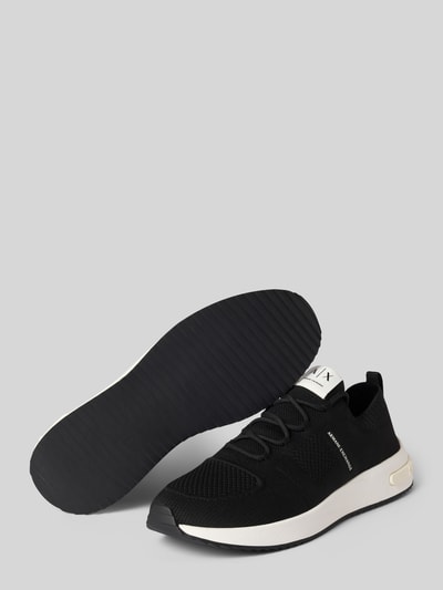 Produktfoto, Sneaker in Schlupfform Modell 'DUSSELDORF' von Armani Exchange in Schwarz mit abgerundeter Spitze, Label-Details, weißer Sohle, Absatzhöhe 3 cm, Schafthöhe 6 cm, Schaftweite 8 cm.