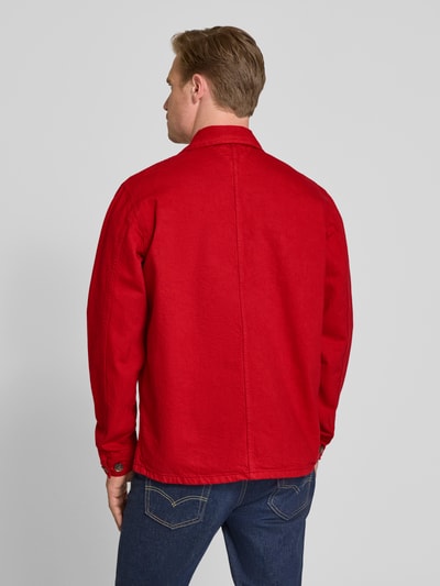 Männermodel trägt Regular Fit Hemdjacke aus reiner Baumwolle von Tommy Hilfiger in Rot, feste Rigid-Textur, Ganzkörperansicht Rückansicht.