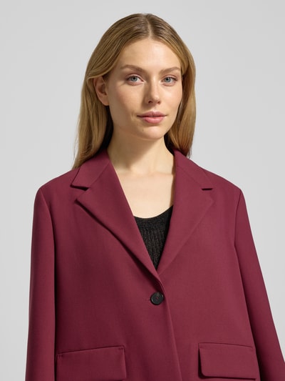 Frauenmodel trägt Boxy Fit Blazer mit Pattentaschen von Windsor in Dunkelrot, Material-Mix mit Viskose-Anteil, Reverskragen, Nahaufnahme Oberkörper.