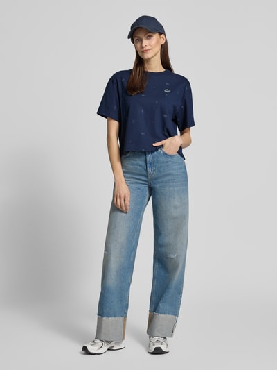 Frauenmodel trägt Oversized T-Shirt aus Baumwoll-Mix von Lacoste Sport, dunkelblau, Tennis-Print, Logo-Patch, Ganzkörperansicht von vorne
