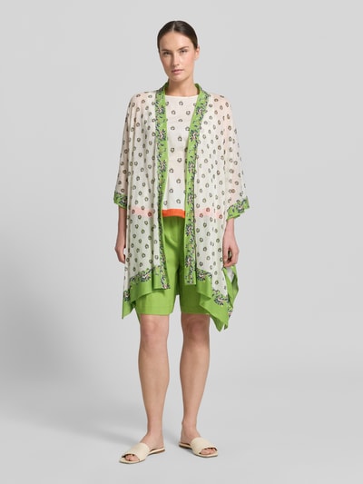 Frauenmodel trägt Cardigan mit offener Front und Kimonoärmeln von Marc Cain aus Baumwoll-Mix im Loose-Fit, creme und grün, Ganzkörperansicht von vorne. Rückenlänge bei Größe 38: 84 cm, Ärmellänge bei Größe 38: 38 cm.