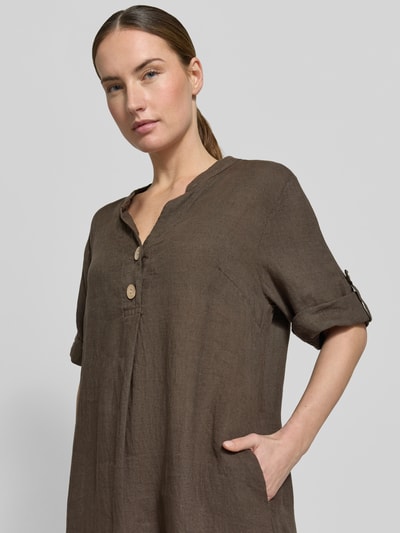 Frauenmodel trägt Tunikakleid aus Leinen mit V-Ausschnitt Modell 'Ki44ra' von ZABAIONE in Braun, Knopfleiste, Ärmel mit Aufschlag, Nahaufnahme Oberkörper. Rückenlänge 95 cm, Brustweite 50 cm, Ärmellänge 26 cm, Gerader-Schnitt.
