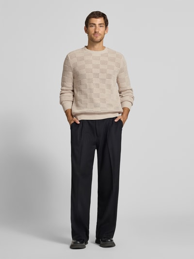 Męski model nosi sweter z dzianiny z okrągłym dekoltem od Antony Morato, 100% bawełna, krój regular fit, wzór na całej powierzchni, długość tyłu 73 cm, długość rękawów 77 cm, widok całej sylwetki z przodu.