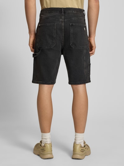 Männermodel trägt Bermudas mit seitlichen Eingrifftaschen und Gesäßtaschen von REVIEW aus Baumwoll-Mix mit Stretch-Anteil, Straight Fit, dunkler Farbton, sichtbare Nähte, Knopf- und Reißverschluss, Bundweite bei Größe M 45 cm, Innenbeinlänge 26 cm, Ganzkörperansicht Rückansicht.