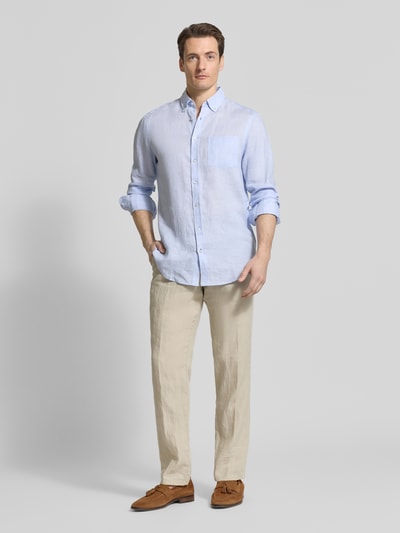 Männermodel trägt Slim Fit Leinenhemd mit Brusttasche von Christian Berg Men in Hellblau, feine Textur, klassische Knopfleiste, Ganzkörperansicht von vorne.