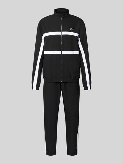 Produktfoto, Regular Fit Trainingsanzug mit Kontraststreifen von Lacoste Sport in Schwarz mit weißen Streifen, elastische Bündchen, Reißverschluss, wasserabweisend, Logo-Details, seitliche Taschen