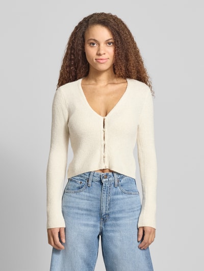 Frauenmodel trägt Regular Fit Strickjacke mit Perl-Optik-Knöpfen Modell 'RICA LIFE' von ONLY, unifarben, Rippstrick, Nahaufnahme Oberkörper.