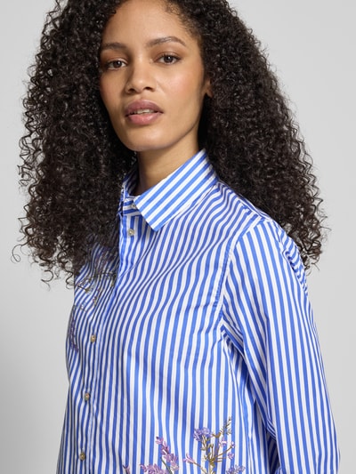 Frauenmodel trägt Regular Fit Hemdbluse mit floralem Print von Christian Berg Woman, blau-weiß gestreift, Baumwolle-Mix, Nahaufnahme Oberkörper.