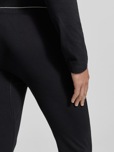 Männermodel trägt Stoffhose mit elastischem Bund von Schiesser, Baumwoll-Elasthan-Mix, körpernaher Schnitt, Nahaufnahme Hüfte.