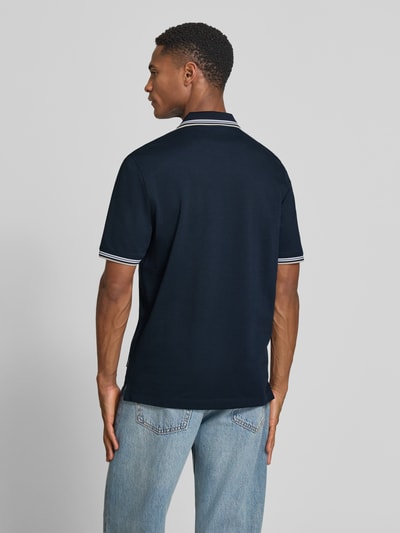 Männermodel trägt Regular Fit Poloshirt mit Logo von bugatti, dunkelblau, Baumwoll-Mix mit Stretch, Rückenansicht Ganzkörperansicht.