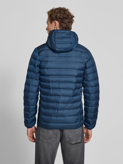 Mężczyznamodel nosi niebieską kurtkę pikowaną Regular Fit Model 'Lake 22™' od Columbia z kapturem, nadrukiem z logo, zamek błyskawiczny, Długość tyłu w rozmiarze M: 72 cm, Szerokość ramion w rozmiarze M: 43 cm, Szerokość klatki piersiowej w rozmiarze M: 42 cm, Długość rękawów w rozmiarze M: 70 cm, Ganzkörperansicht Rückansicht