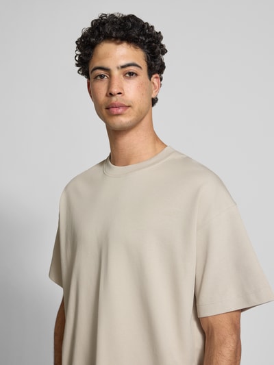 Männermodel trägt Herren T-Shirt mit Rundhalsausschnitt Modell 'BARRON' von Jack & Jones, beige, Baumwoll-Mix mit Stretch-Anteil, Relaxed-Fit, Nahaufnahme Oberkörper.