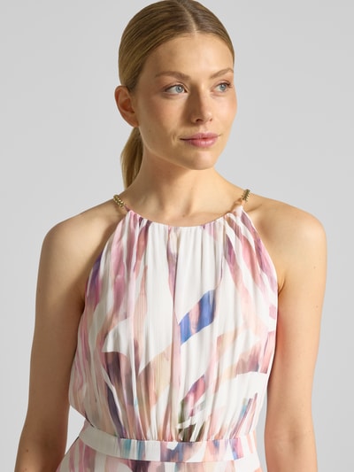 Frauenmodel trägt Abendkleid mit rückseitigem Schlüsselloch-Ausschnitt von Swing in sanften Pastellfarben, Zierperlen am Spaghettiträger, Nahaufnahme Oberkörper.