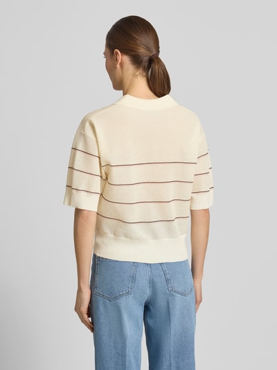 Modelka kobieca nosi Strickshirt aus Viskose-Mix mit Polokragen Modell 'Pringi' od OPUS, krój regular fit, kremowy z czerwonymi paskami, długość pleców 52 cm, długość rękawa 24 cm, widok sylwetki od tyłu.