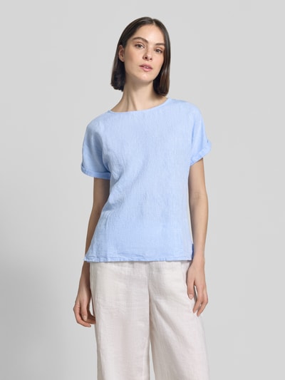 Frauenmodel trägt Leinenbluse mit fixiertem Ärmelaufschlag von Christian Berg Woman in Hellblau, Straight Fit, Rundhalsausschnitt, reine Leinen-Textur, Rückenlänge 60 cm, Ärmellänge 10 cm, Ganzkörperansicht von vorne.