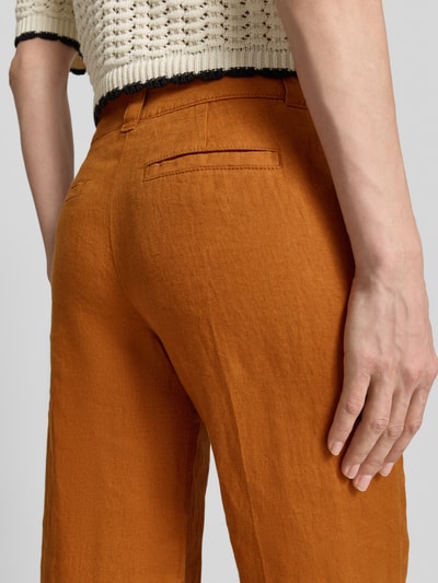 Frauenmodel trägt Leinenhose mit Eingrifftaschen von Christian Berg Woman in Orange, Reines Leinen, Regular-Fit, Nahaufnahme Hüfte.