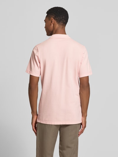 Męski model nosi Regular Fit Poloshirt aus reiner Baumwolle von s.Oliver RED LABEL, jednolity kolor, krój regular fit, materiał pique, bawełna; widok całej sylwetki z tyłu.