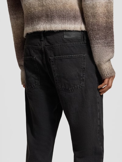 Männermodel trägt Relaxed Fit Jeans mit Eingrifftaschen Modell 'CHRIS' von Jack & Jones, Reine Baumwolle, schwarze Waschung, Detailaufnahme Rückansicht.