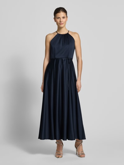 Frauenmodel trägt Cocktailkleid aus Satin mit Bindegürtel von Jake*s Cocktail, dunkelblau, A-Linie, Neckholder, Ganzkörperansicht von vorne.