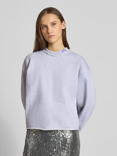 Frauenmodel trägt Oversized Sweatshirt aus reiner Baumwolle Modell 'Dismudge_B' von HUGO BLUE, Optik: Unifarben, Logo-Stitching, Rundhals, Langarm, Sweat-Material, Ganzkörperansicht von vorne.