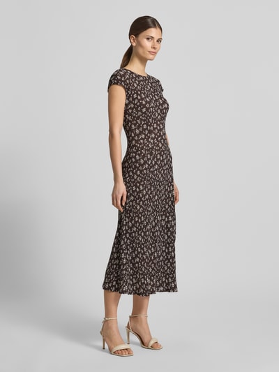 Frauenmodel trägt figurbetontes Midikleid im Allover-Look Modell 'POME' von Mango, rundhals, florales Muster, Ganzkörperansicht von vorne.