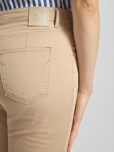 Vrouwenmodel draagt Hose in verkürzter Passform Modell 'Mary' van Brax in beige, katoenmix met lyocell, detailopname achterkant.