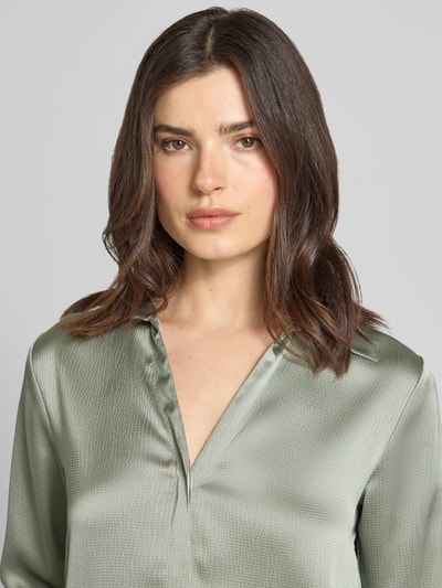 Vrouwenmodel draagt Regular Fit blouse met V-hals van Calvin Klein Womenswear in lichtgroene materiaalmix met stretch, blouse met overhemdkraag en verdekte knoopsluiting, detailopname bovenlichaam.