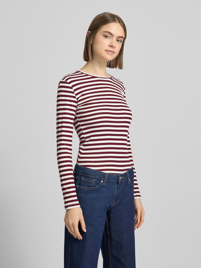 Frauenmodel trägt Slim Fit Langarmshirt aus Baumwoll-Mix von Pieces, gestreift, Two Tone, Rippstrick, unifarben, Ganzkörperansicht von vorne.