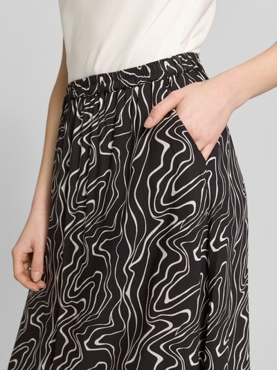 Frauenmodel trägt Ausgestellter Maxi-Rock aus reiner Viskose Modell 'EASY JOY' von Vero Moda mit Optik:Allover-Muster, Nahaufnahme Oberkörper.