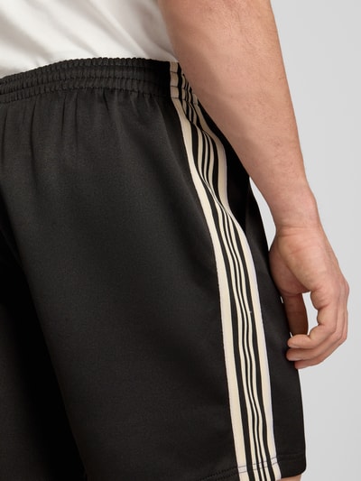 Männermodel trägt Regular Fit Sweatshorts mit elastischem Bund Modell 'RIBER' von Only & Sons, Optik: Unifarben, Kontraststreifen, Eingrifftaschen, Detailaufnahme