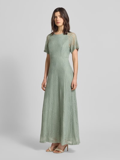 Frauenmodel trägt Maxikleid aus Spitze mit Rundhalsausschnitt Modell 'FEMMA' von Vila, Material-Mix mit Stretch-Anteil, gerader Schnitt, sanftes Mintgrün, feine Textur, Ganzkörperansicht von vorne.