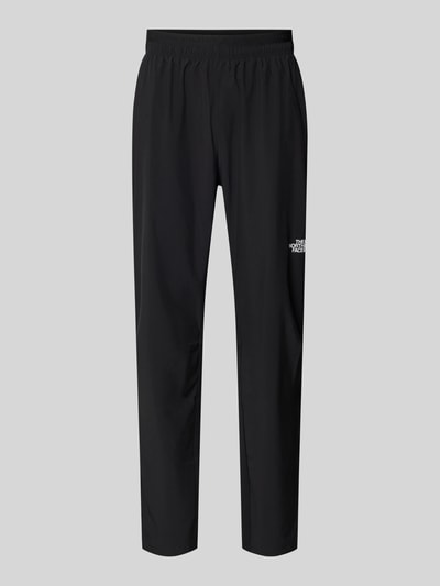 Produktfoto, Trainingshose mit elastischem Bund und Logo von The North Face in Schwarz, Regular Fit, Stretch-Material, glatte Struktur