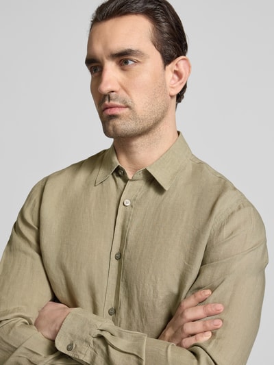 Männermodel trägt Regular Fit Leinenhemd mit Kentkragen Modell 'Spenser' von Tiger Of Sweden in hellem Beige, Nahaufnahme Oberkörper. Herren Leinenhemd, reine Leinenstruktur, Knopfleiste, Rückenlänge 77 cm, Schulterbreite 48 cm, Ärmellänge 69 cm.