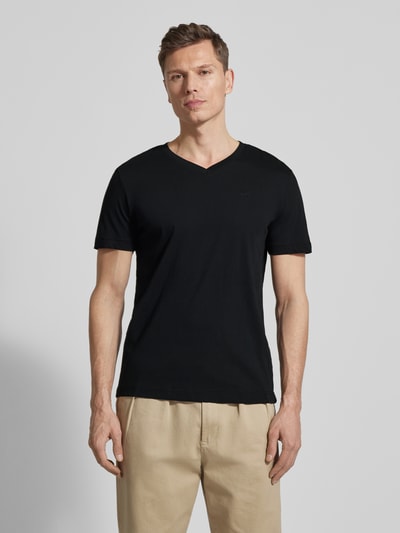 Männermodel trägt Regular Fit T-Shirt aus reiner Baumwolle von Tom Tailor, unifarben, V-Ausschnitt, kurzarm, Logo-Stitching, Ganzkörperansicht von vorne.