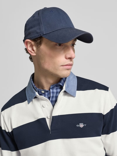 Männermodel trägt Sweatshirt mit Label-Stitching von Gant, breite blaue und weiße Streifen, Polokragen, Nahaufnahme Oberkörper.
