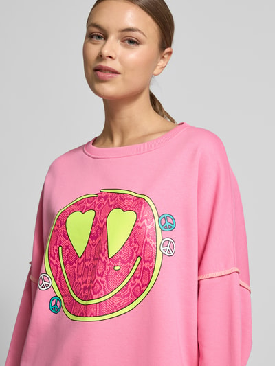 Kobiece modelka nosi Oversized Sweatshirt mit Motiv-Print od miss goodlife, różowy kolor, bawełna, nadruk, zbliżenie na górną część ciała.