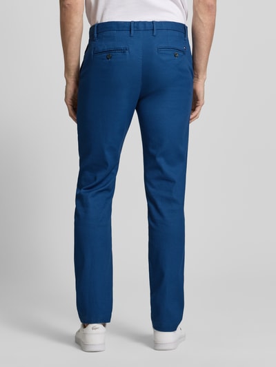 Männermodel trägt Slim Fit Chino aus Baumwoll-Mix von Tommy Hilfiger in Blau mit Logo-Stitching, Slim Straight Fit, Ganzkörperansicht Rückansicht