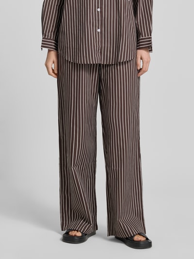Frauenmodel trägt Weite Hose aus reiner Baumwolle Modell 'MAVIE' von VILLA SOPHIE mit Optik:Allover-Muster, Regular-Fit, High-Waist, elastischem Bundabschluss, seitliche Eingrifftaschen, Label-Patch, glatte braune und weiße Streifen, Ganzkörperansicht von vorne.
